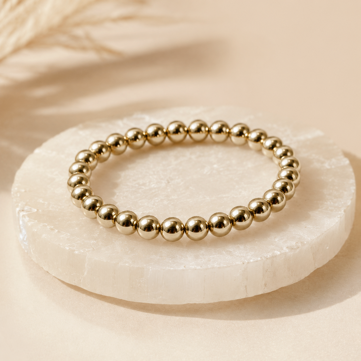 Gold Hematite Bracelet — angled view of mirror-polished beads — KaalVeda